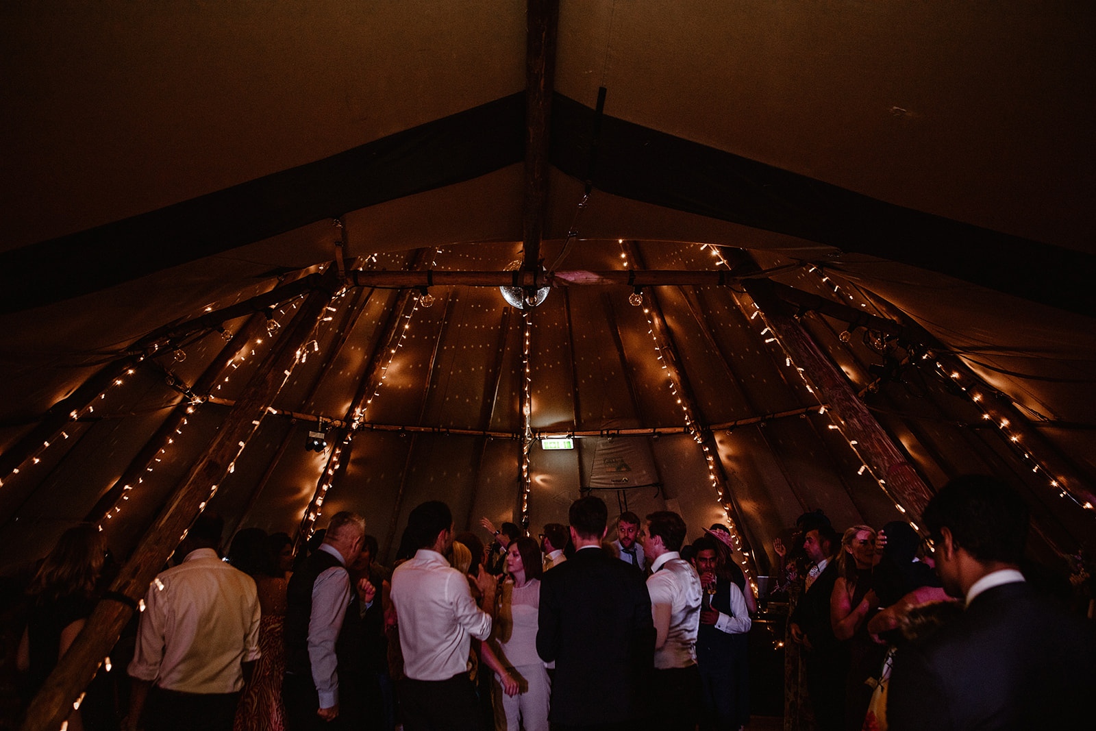 Beautifully accessorised tipi interior with lighting and furniture